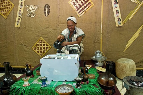 Ethiopian woman pours coffee in a traditional coffee ceremony