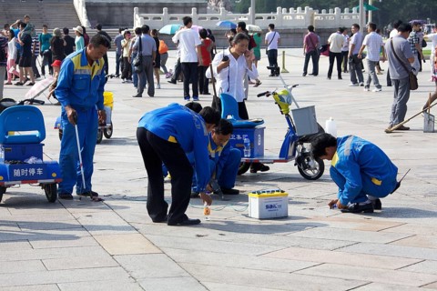 Workers removing chewing gum from Tiananmen Square