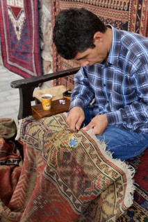 Man repairing a used carpet