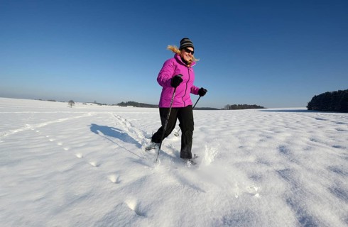 Woman snowshoe walking