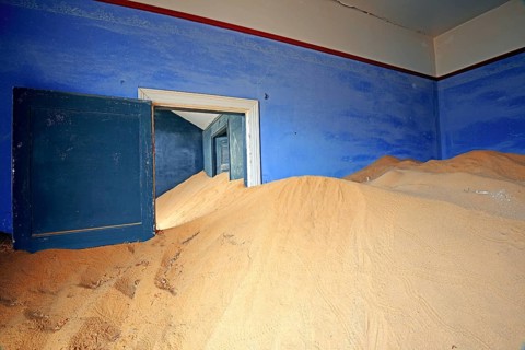 Building taken over by sand from the desert