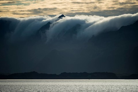 Clouds rolling over mountains