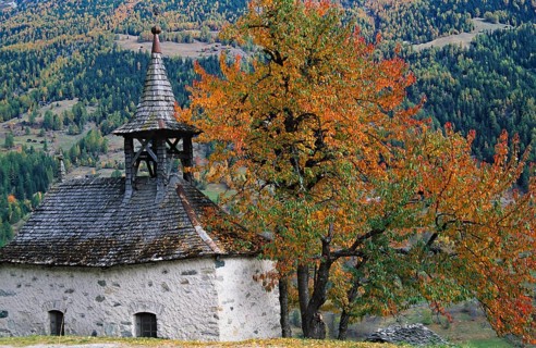 Chapel of Grimentz with trees in autumn