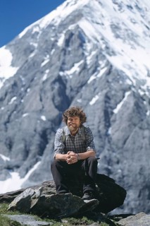 Mountaineer Reinhold Messner sitting in front of Mt Koenigsspitze
