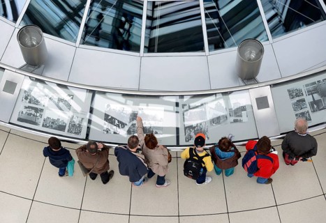 Visitors viewing an exhibition in the interior of the dome of the Reichstag Building