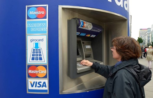 Woman operating an EC-ATM for VISA