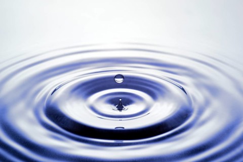 Water droplets falling onto water surface