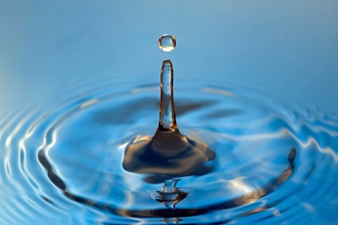 Water droplets falling onto water surface