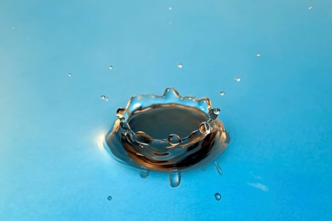 Water droplets falling onto water surface