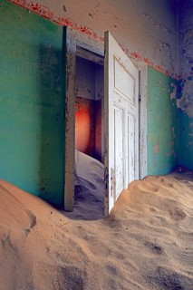 Building taken over by sand from the desert