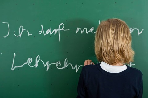 Schoolboy writing on the blackboard as a penalty
