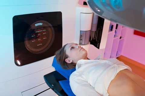 Patient lying in a linear particle accelerator for radiation treatment