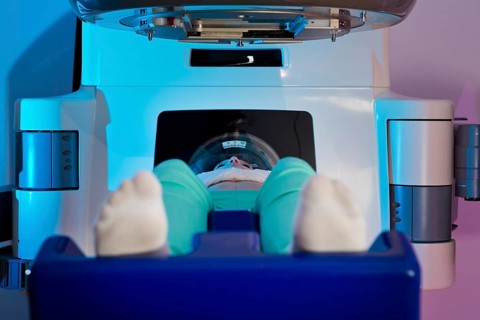 Patient lying in a linear particle accelerator for radiation treatment