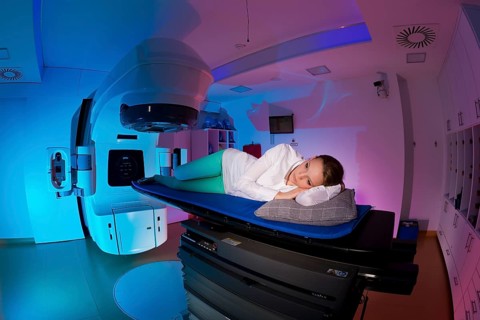 Patient lying in a linear particle accelerator for radiation treatment of the foot