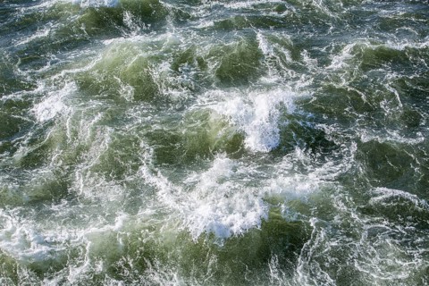 Rough waters of a river swirling after emerging from a barrage