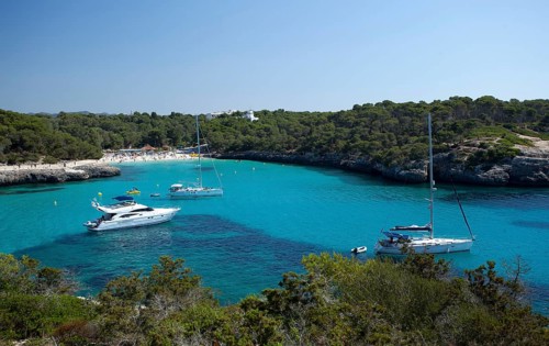 Sailing boats at sandy beach of Calo d'en Garrot