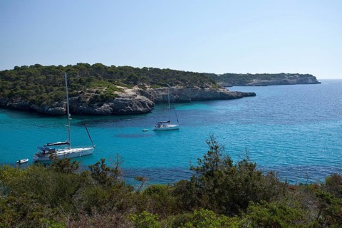Sailing boats in the Calo d'en Garrot bay