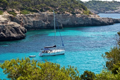 Sailing boat in the rocky bay of Calo d'en Garrot
