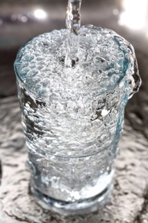 Water overflowing in a glass