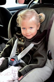 Girl in a car safety seat in a car