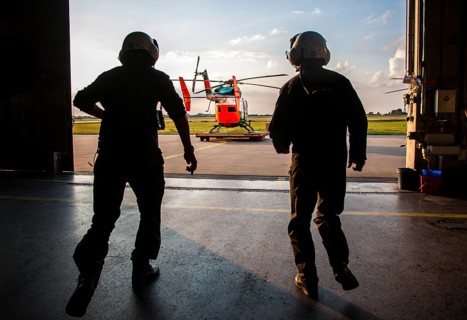 Pilots sprinting towards a helicopter