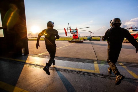 Pilots sprinting towards a helicopter