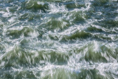 Rough waters of a river swirling after emerging from a barrage