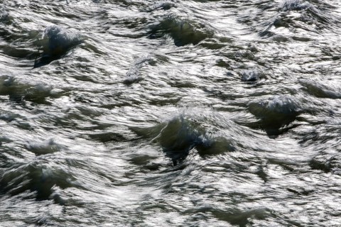 Rough waters of a river swirling after emerging from a barrage