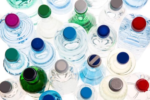 Different varieties of mineral water in bottles made of glass and plastic or PET