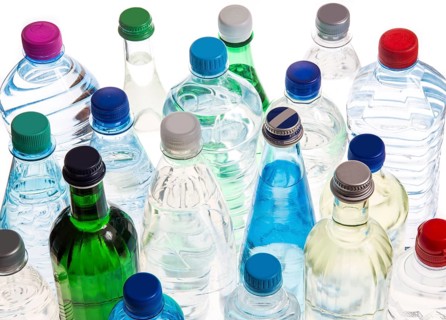 Different varieties of mineral water in bottles made of glass and plastic or PET