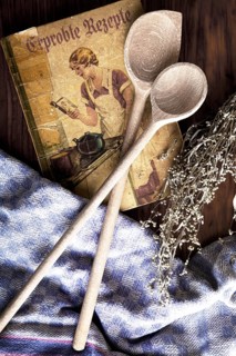Old cookbook with wooden spoons