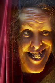 Face of a grinning wax figure with broken teeth