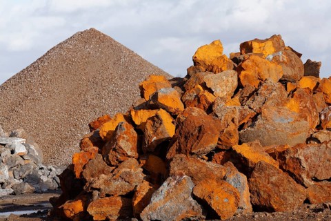 Stack of rusty ferruginous rocks waiting to be recycled