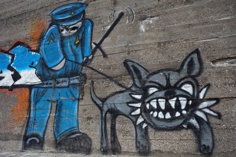 Policeman with a tough dog