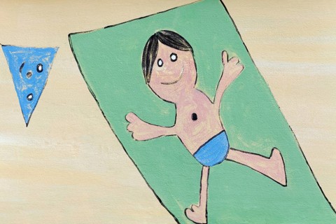 Boy lying on a beach towel