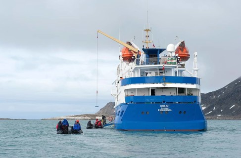 Passengers returning after being ashore in Zodiac inflatable boats to the expedition cruise ship