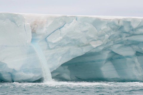 Meltwater waterfall at the glacier front of Brasvellbreen
