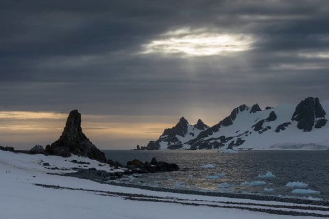 Sunrays shining through a hole in the clouds at Half Moon Island