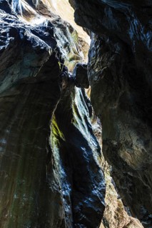 Boulder wedged between two rock faces