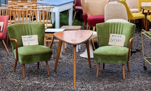 Table and armchairs from the 1960s are offered for sale at a flea market