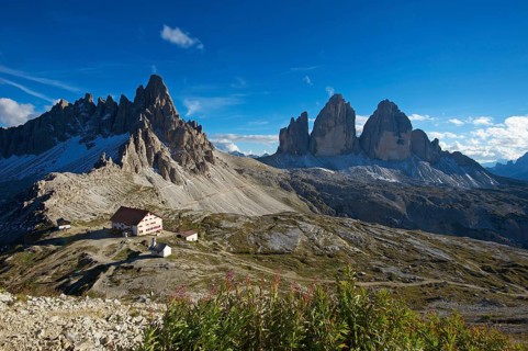 Dreizinnenhuette or Three Peaks Alpine hut and chapel in front of Paternkofel Mountain and the north face of the Three Peaks