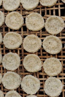 Round rice cakes made of glutinous rice drying on a bamboo frame