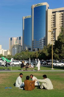Locals in a park in front of the Rolex Towers