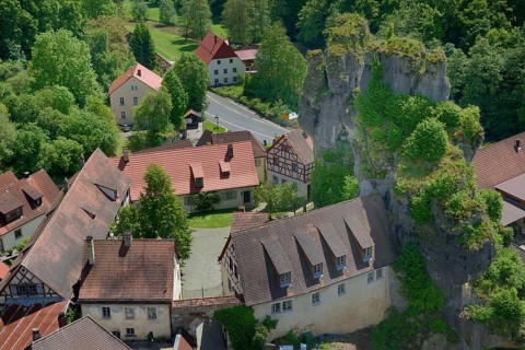 Half-timbered houses next towering karst rocks