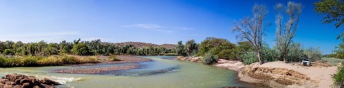 Off-road vehicle parked beside the Kunene River