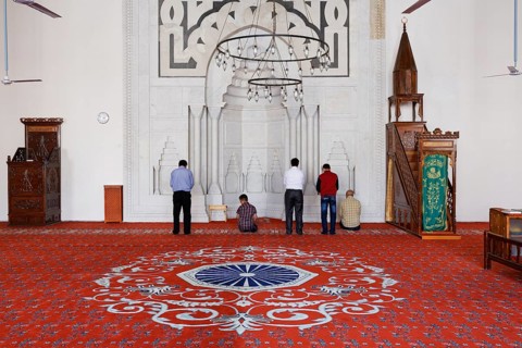 Muslims praying in the prayer room of the Isabey Mosque