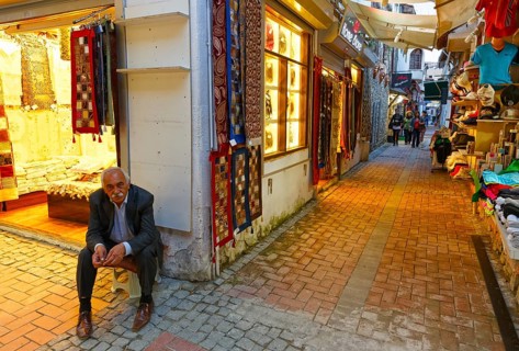 Man sitting outside a carpet shop in the Bazaar of Kusadasi