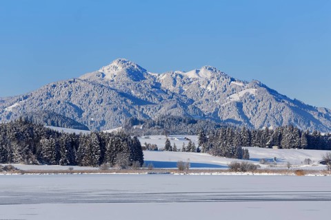 Frozen Hopfensee Lake with Mount Edelsberg and Mount Alpspitz