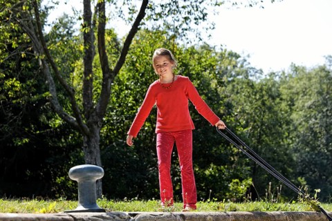 Girl fastening a rope to secure the boat in the lock chamber
