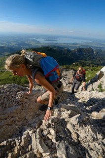 Hikers climbing to the summit of Kampenwand Mountain
